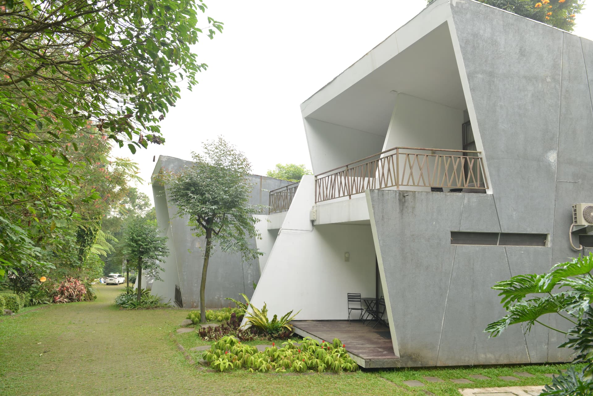 Modern sculptural villa units with terraces along the garden path